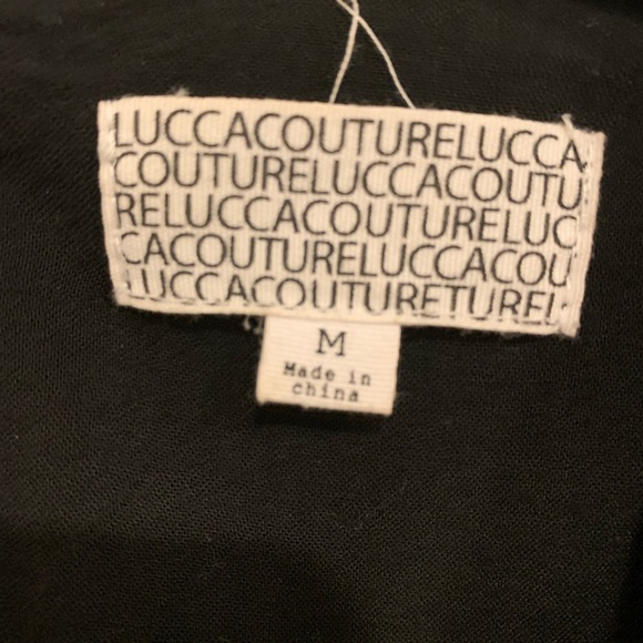 Like new condition black tunic dress with sheer sleeves and brass grommets - Picture 2 of 2